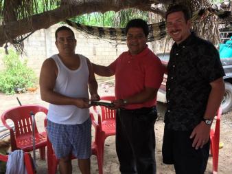 Pastor Leo Handing Bible to Brother Martin Flores